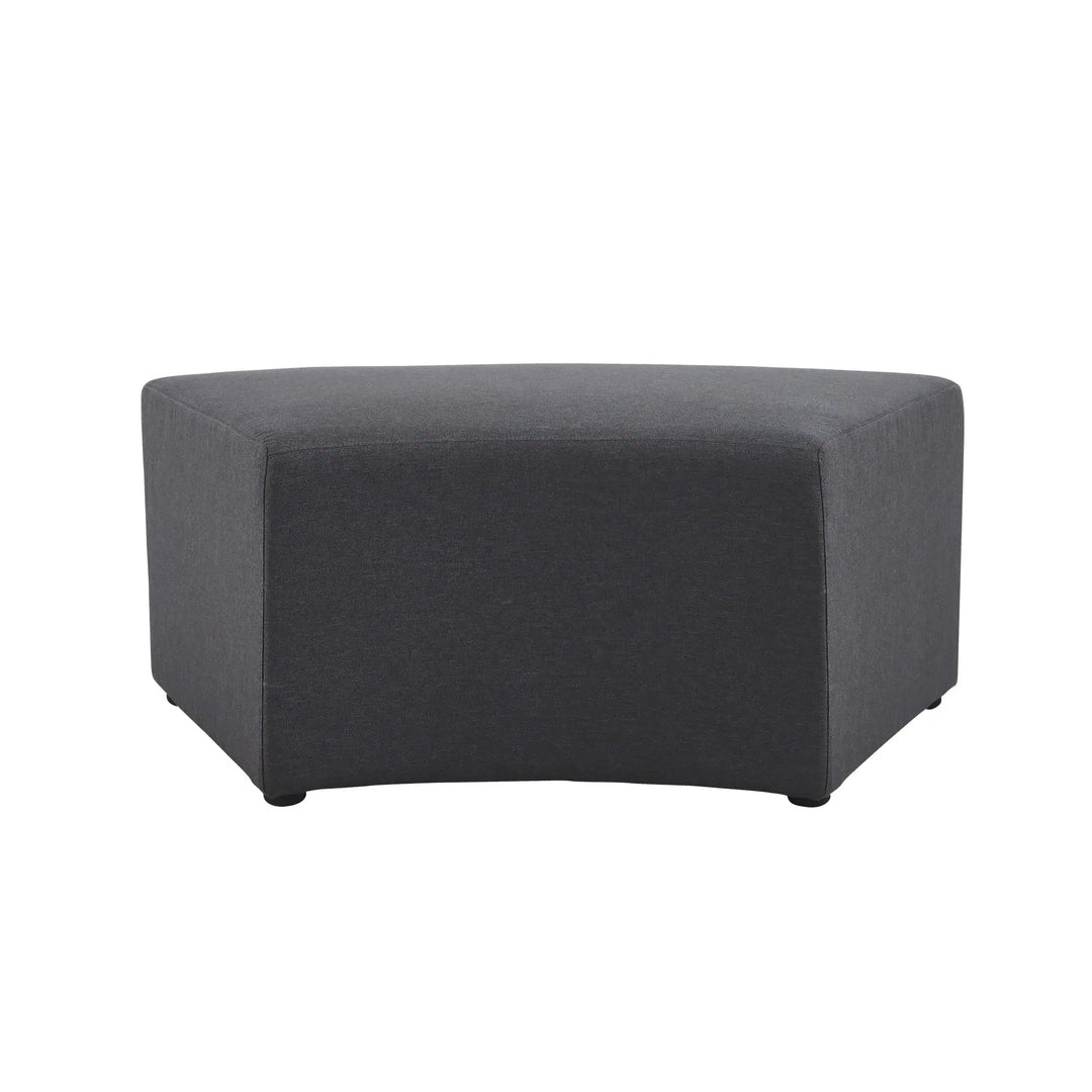 The Konfurb Arco Series by Home Office Space NZ is a dark gray, wedge-shaped ottoman featuring a smooth, minimalist design and short black legs. With its slightly curved front and straight sides, this piece is ideal for contemporary living spaces and evolving work environments. It forms part of a modular seating system tailored for exceptional design.