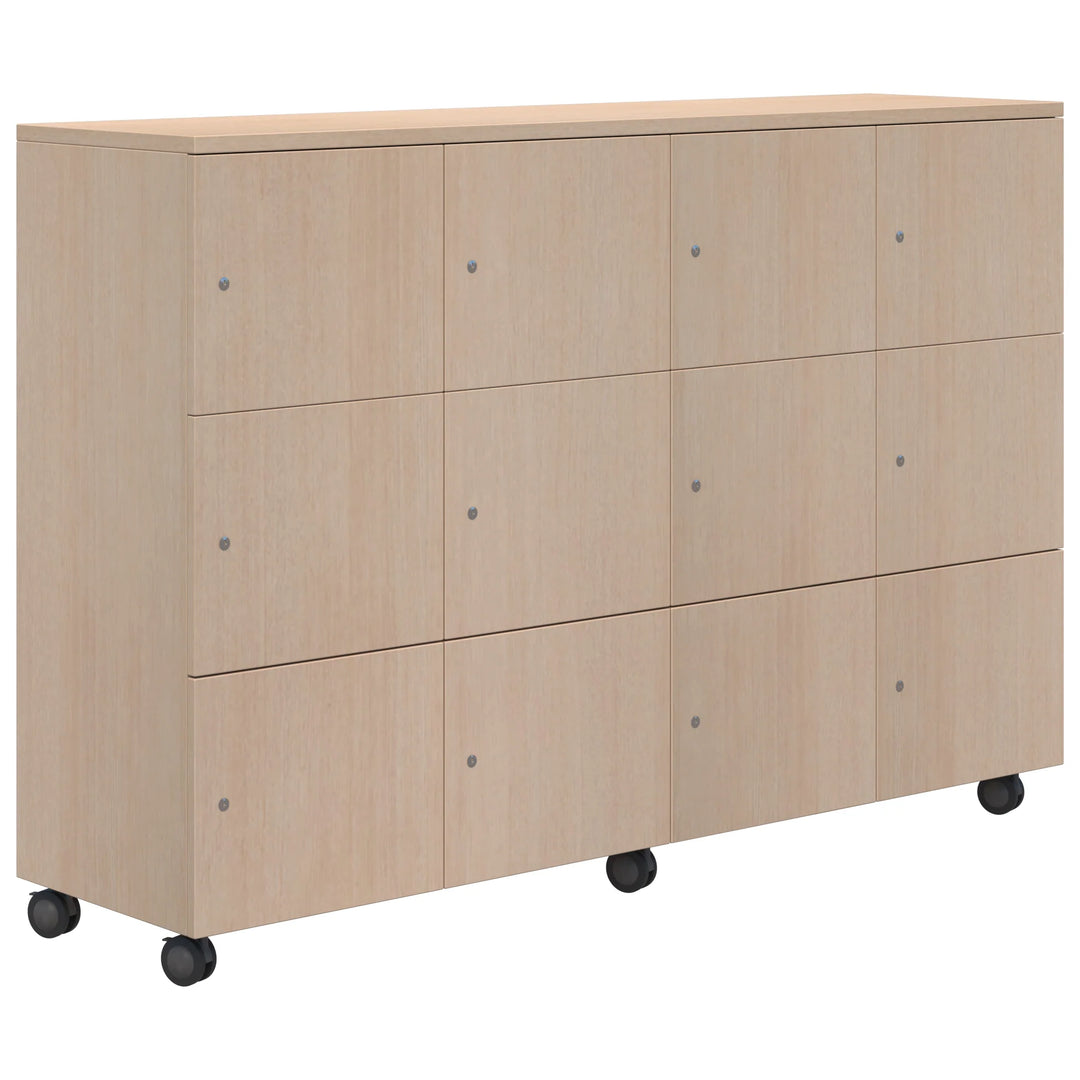 The Mascot Lockers by Home Office Space NZ feature a light wood cabinet with twelve doors in a 3x4 layout, round handles, and four black caster wheels—ideal for secure, customizable storage in any space.