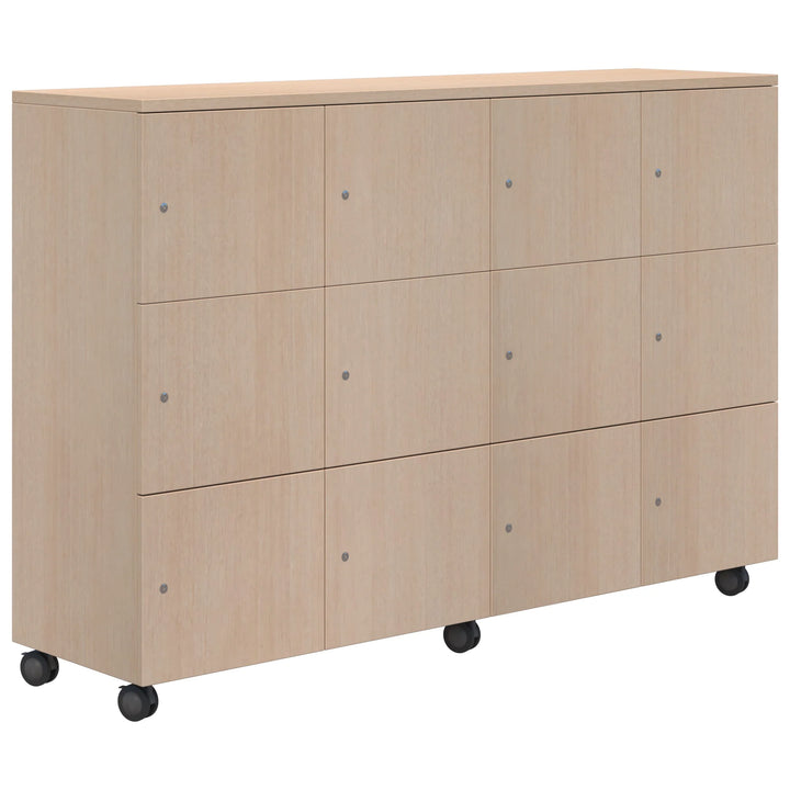 The Mascot Lockers by Home Office Space NZ feature a light wood cabinet with twelve doors in a 3x4 layout, round handles, and four black caster wheels—ideal for secure, customizable storage in any space.